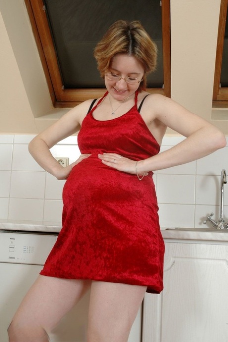Prego Kitty shows off her hairy pussy on the kitchen counter & eats a banana