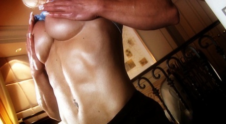 Mature bodybuilder Brigita Brezovac massages her boobs & shows her big biceps