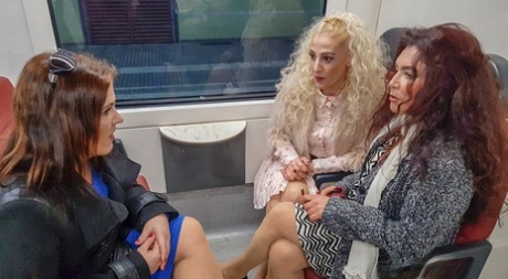 Old & young lesbians pose seductively on the couch after a train ride