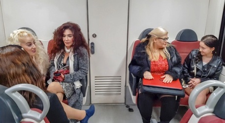 Old & young lesbians pose seductively on the couch after a train ride